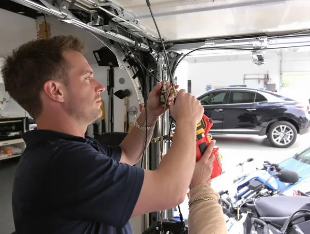 Greenwich Garage Door Repair safety certified technician performing cable replacement in Greenwich
