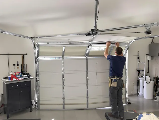 Greenwich Garage Door Repair specialist performing precise section replacement on Greenwich garage door